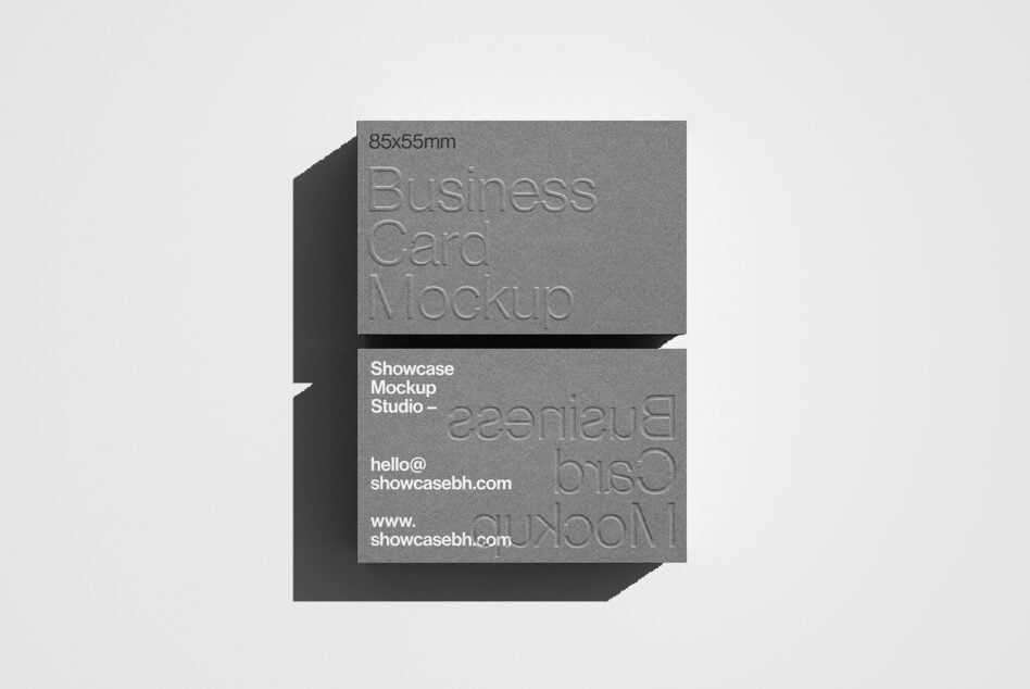 Minimalist business card mockup with embossed text on a grey surface ideal for design showcase templates branding and presentation for designers.