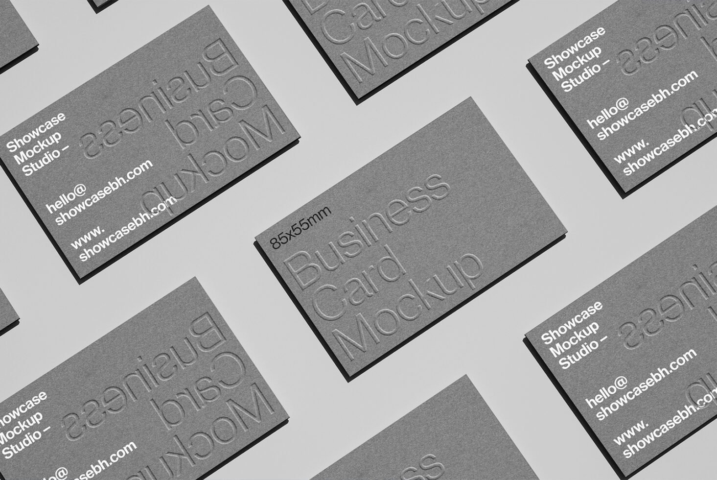 Business card mockup with embossed text on gray background ideal for designers. Perfect for showcasing branding concepts and graphic design projects.