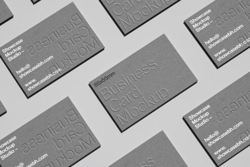 Business card mockup with embossed text on gray background ideal for designers. Perfect for showcasing branding concepts and graphic design projects.