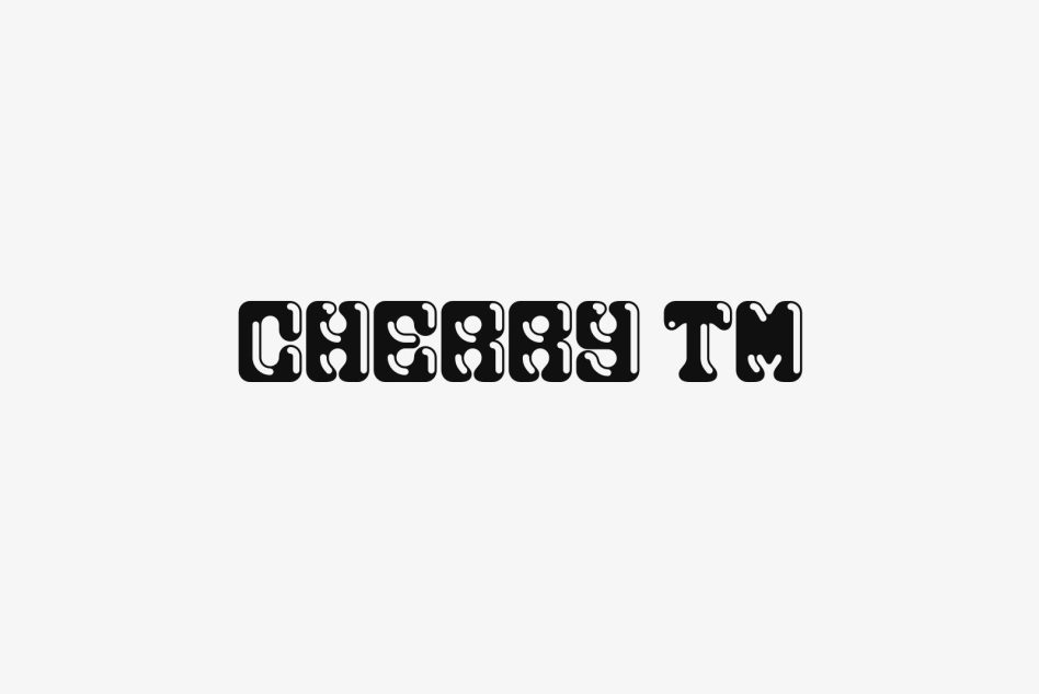 Black ornamental patterned typeface displaying Cherish TM centered on minimal light background