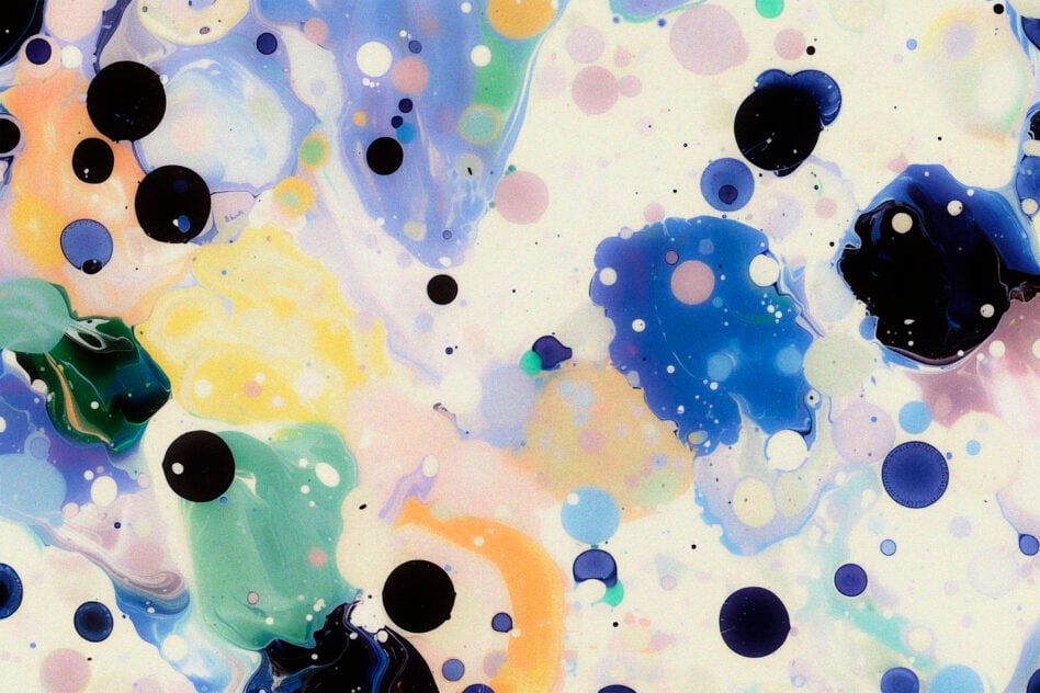 Rainbow ink drops spreading across white with bold black circles scattered