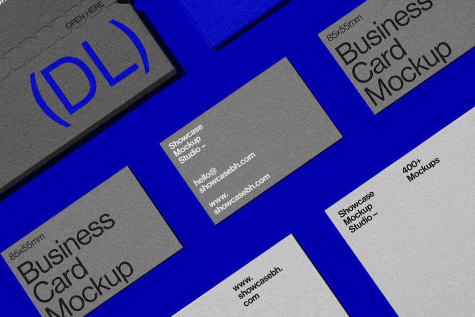 Business cards scattered on bright blue surface with embossed branding