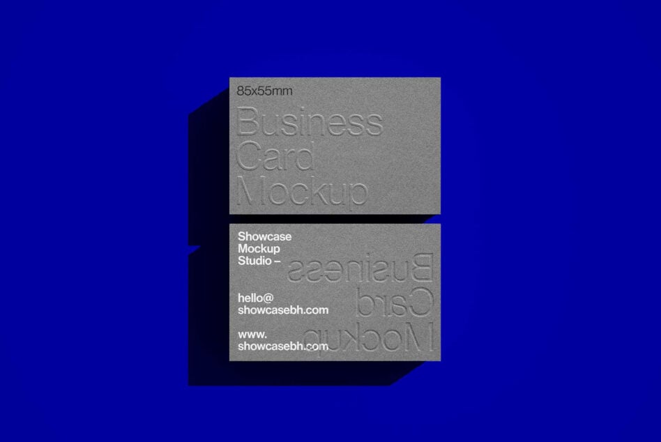 Business card mockup with embossed text on dark blue background. Perfect for showcasing design templates. Ideal for designers and branding projects.