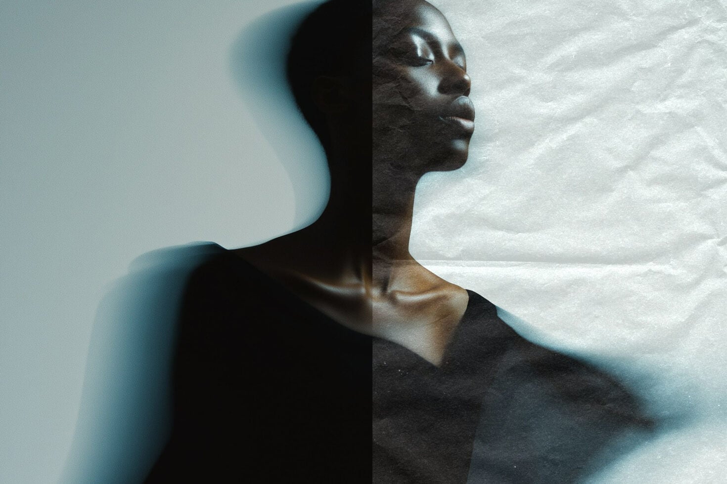 Double exposure portrait split between shadowy silhouette, textured face side view dreamy