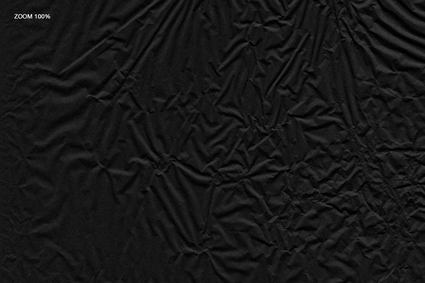 Crumpled black fabric texture close up at full zoom showing wrinkles, creases