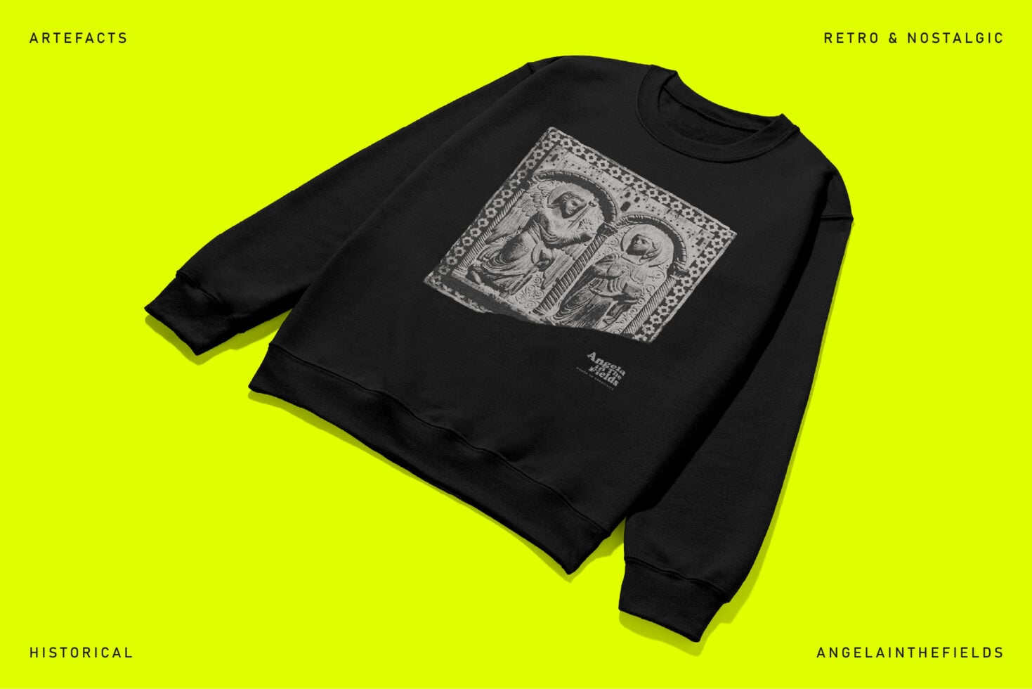 Black sweatshirt with etched religious relief art on bright yellow background