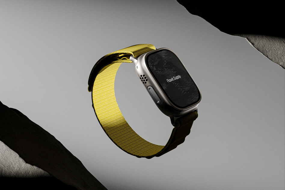 Silver smartwatch with yellow sport band on light gray surface