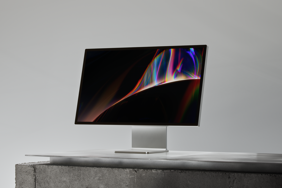 Monitor displaying vibrant rainbow light effect on desk setup