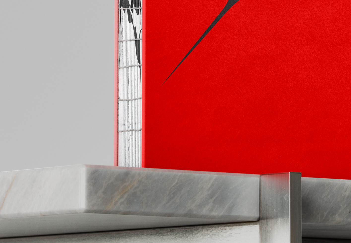 Close-up of a modern book with red cover and artistic binding detail on a marble and metal surface perfect for designers seeking book cover mockups