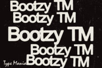 Bootzy TM typeface displayed repeatedly in cream on rough dark surface