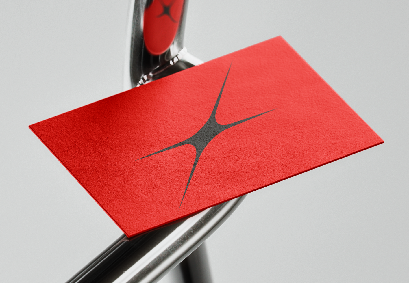 Red business card mockup with abstract logo on a metallic surface suitable for branding presentations and design projects for graphic designers.