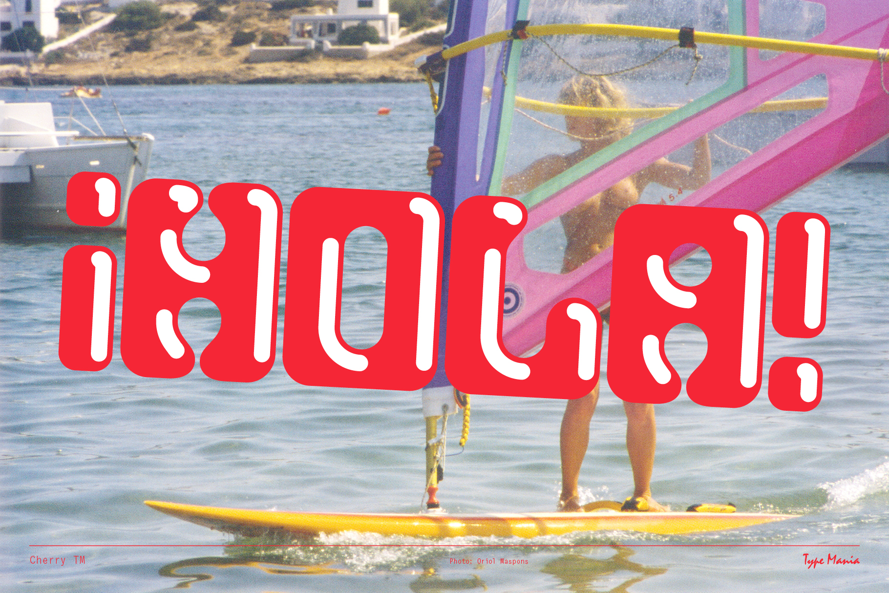 Bold red typography spelling Hola overlays a vibrant windsurfing scene on the ocean. Ideal for graphic design projects seeking playful retro fonts.