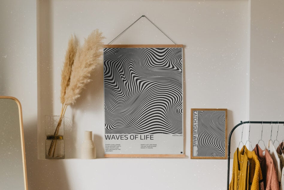Abstract black white poster mockup with wavy lines hanging on wall near pampas grass decor. Ideal for graphics display design inspiration creative projects.