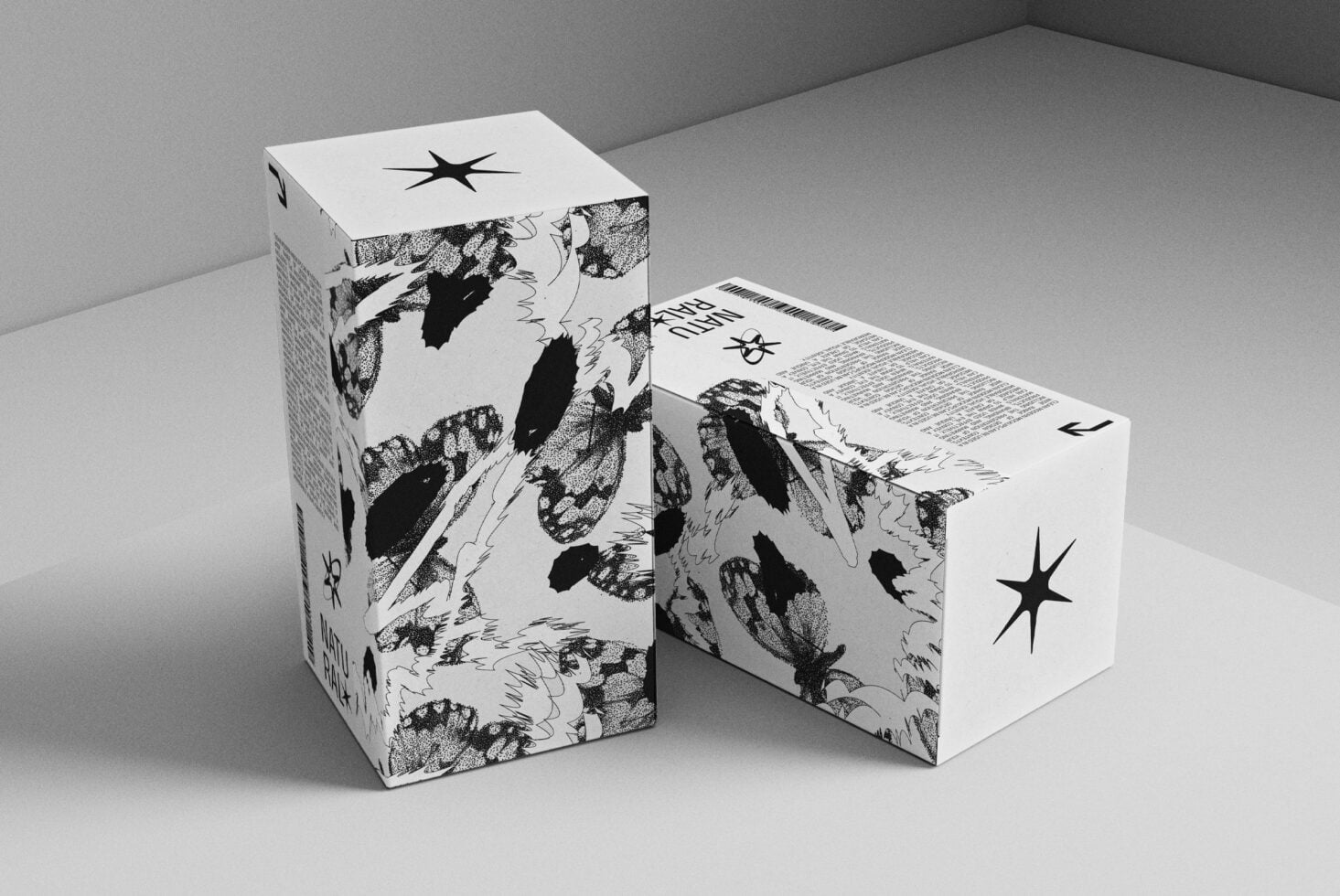 Two white boxes with dotted animal graphics displayed at angle on minimal gray surface