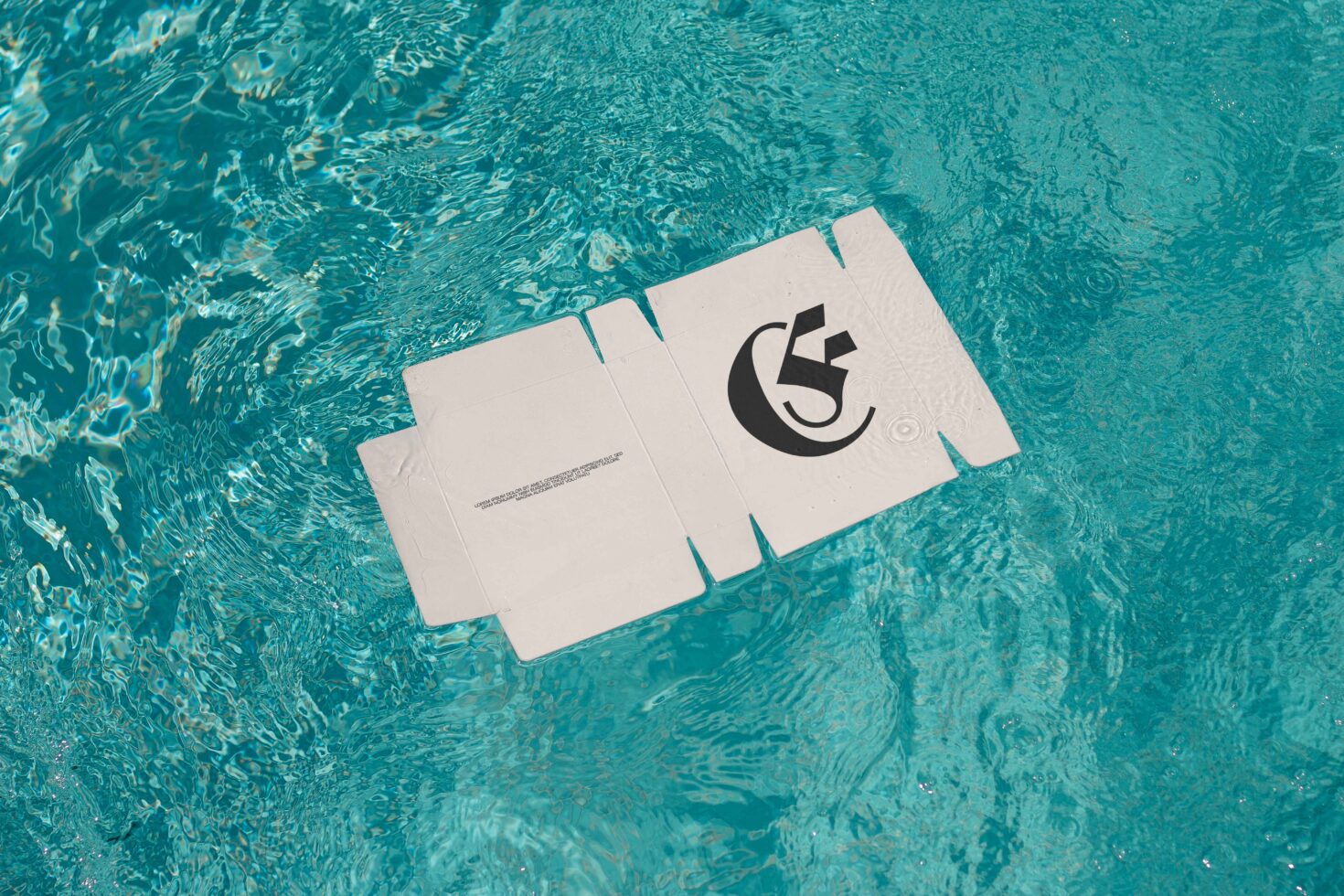 Floating cardboard mockup with logo on turquoise water surface. Ideal for designers seeking unique branding and packaging presentation.