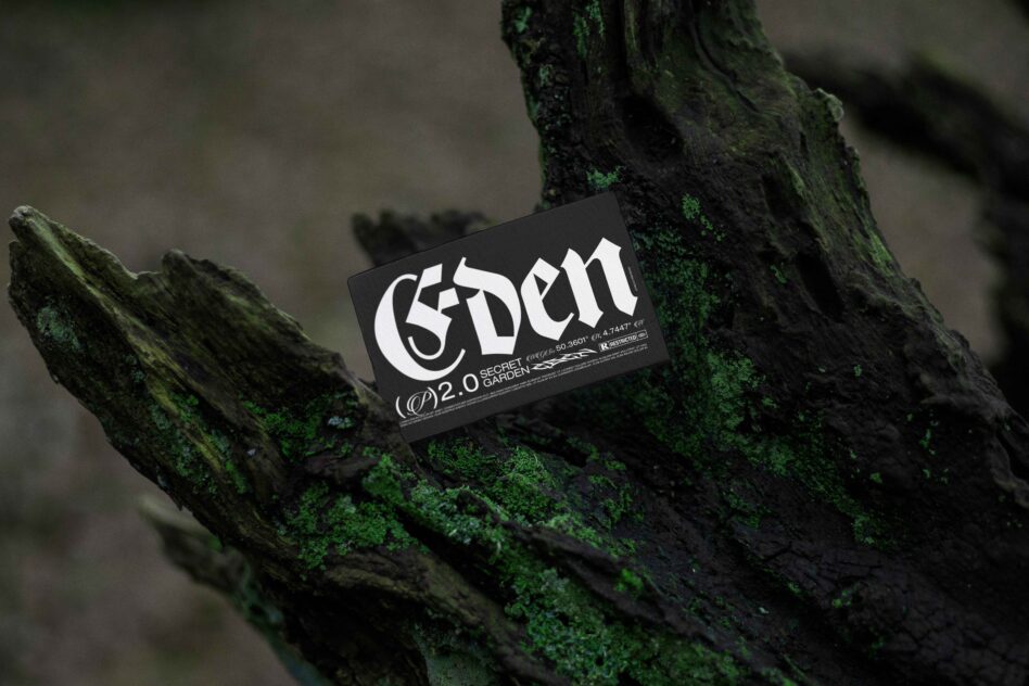 Gothic style black card with Eden text on mossy green wood background digital mockup design asset for designers branding and typography projects.