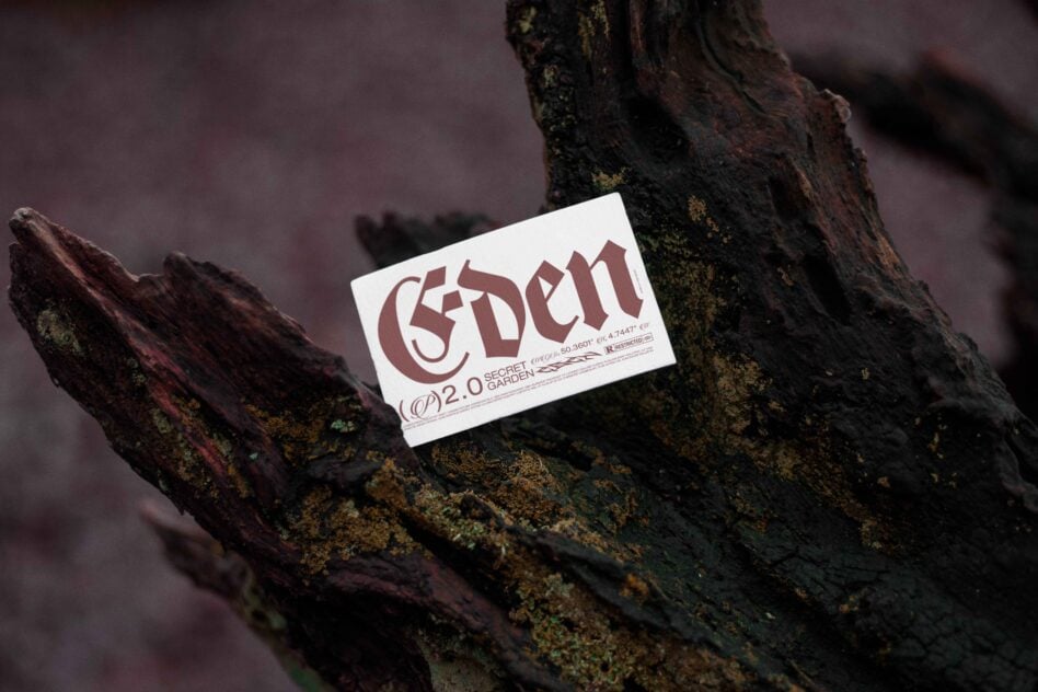 Business card mockup on textured wood surface featuring bold gothic-style typography Eden design unique template digital asset for designers.