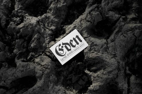 Business card mockup with bold typography labeled Eden on rugged soil background. Ideal for designers seeking creative layout inspiration. Editable template.