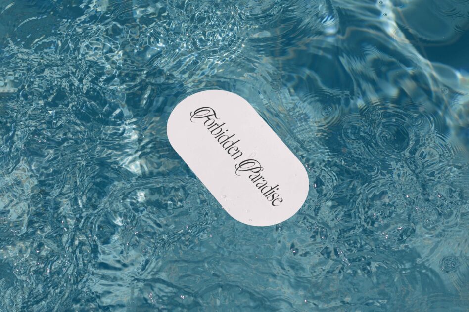 White rounded label mockup sitting on rippling water with light reflections