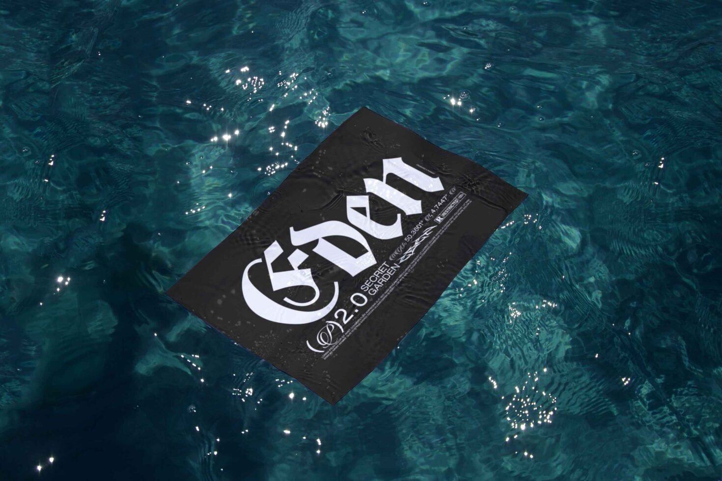 Black paper with gothic font floating on water, showcasing elegant typography. Ideal for branding mockups, graphic designers, and font enthusiasts.