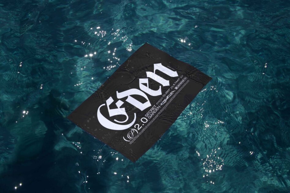 Black business card floating on rippling teal water with sunlight reflections
