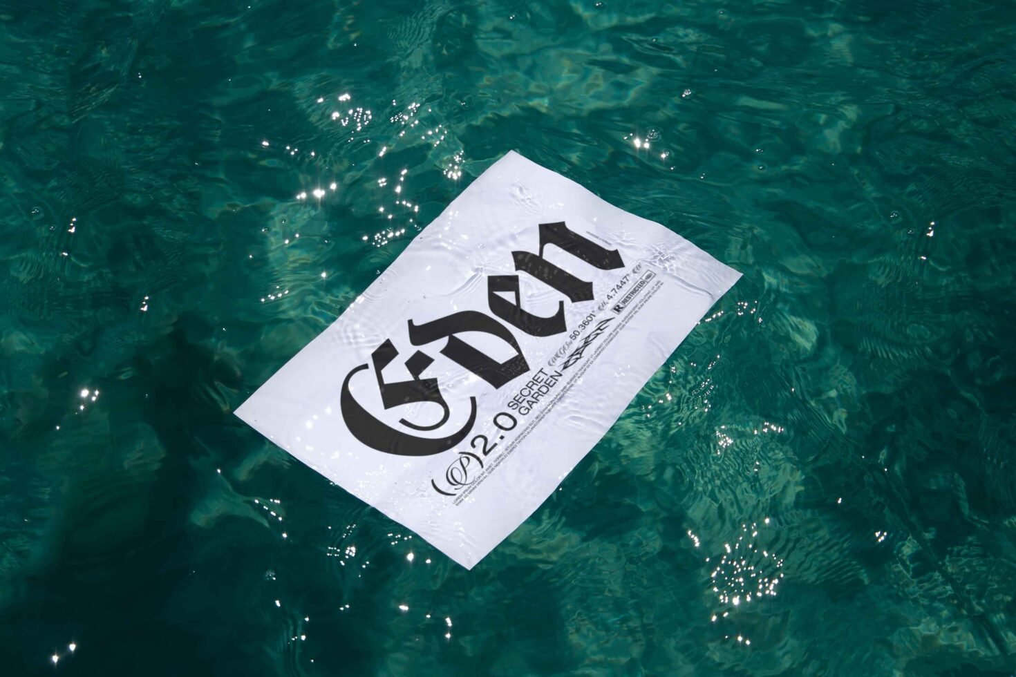 Floating poster on turquoise ocean water displaying bold gothic font Eden suitable for graphic designers and mockup assets digital design templates.