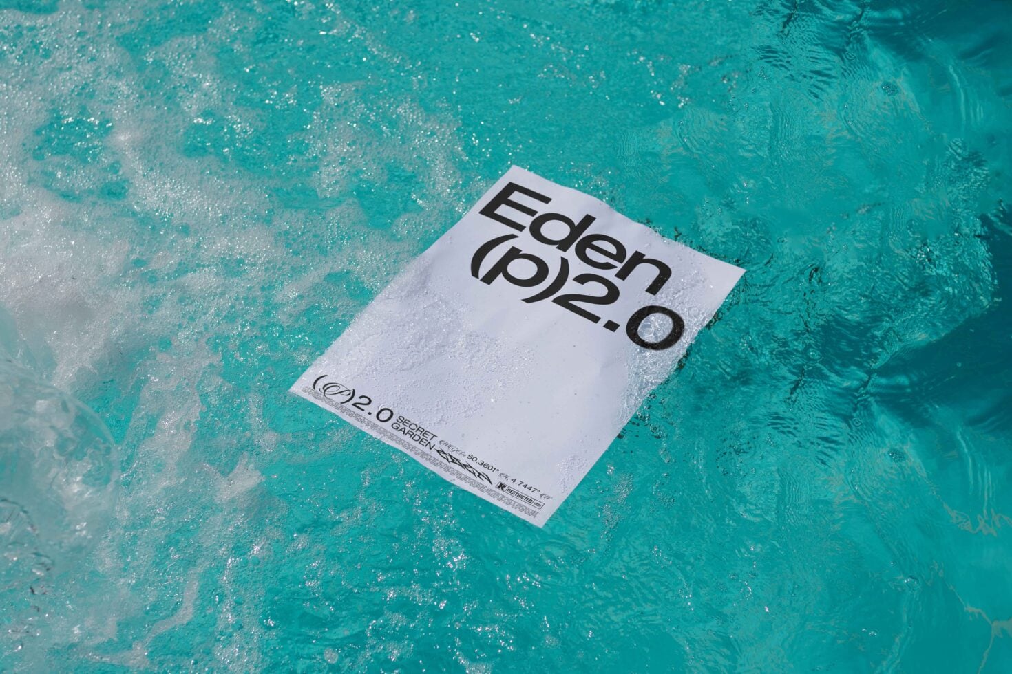 White postcard on turquoise water displaying Eden 2.0 text overlay design