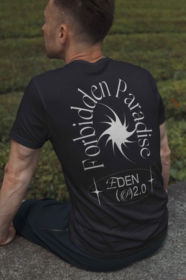 T-shirt mockup featuring a man seated outdoors wearing a dark tee with Forbidden Paradise graphic and unique typography perfect for graphic designers and templates.