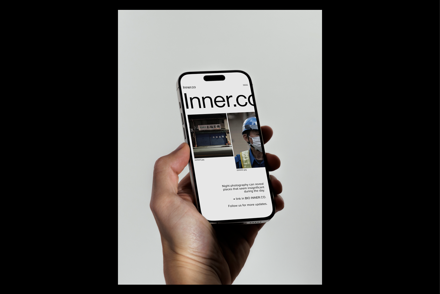 Hand holding smartphone displaying a web page design mockup focused on urban photography content, ideal for UI UX designers and app developers.
