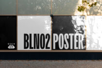 Poster mockup design on a large window display with bold typography reading BLNO2 POSTER ideal for graphic designers marketing and advertising projects.