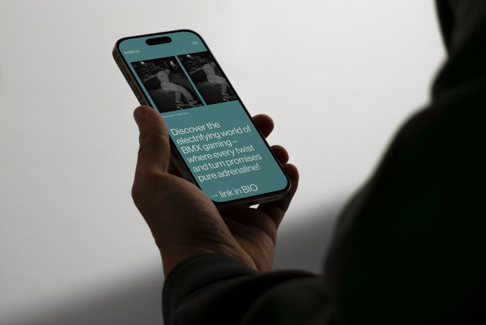 Mockup of a hand holding a smartphone displaying BMX gaming content. Ideal for designers seeking mobile app presentation assets. Tech, UX, digital marketing.