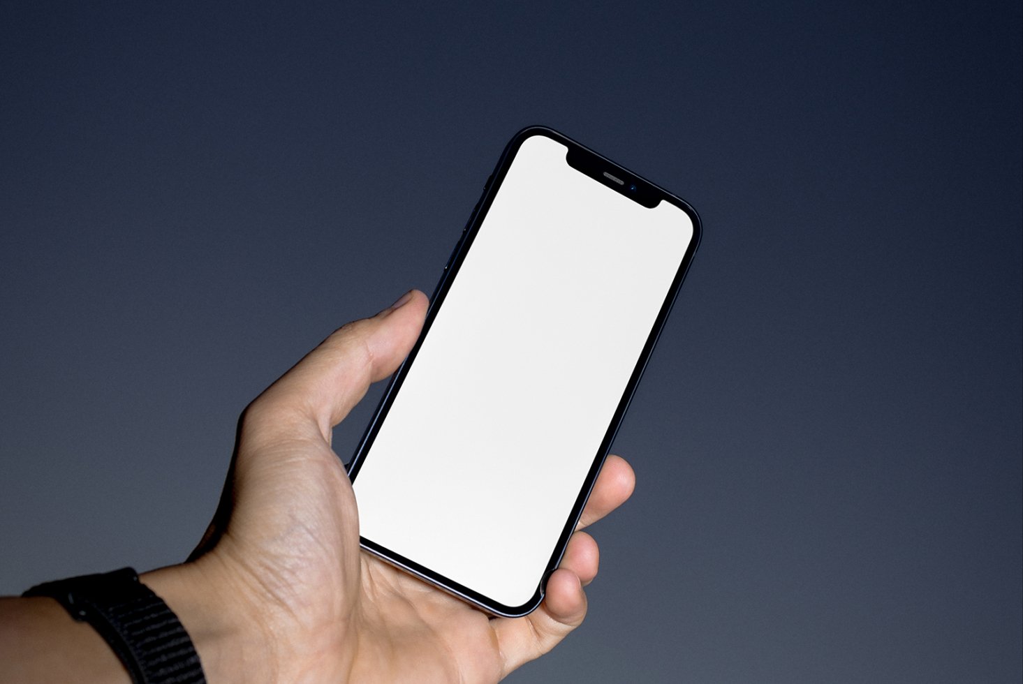 Hand holding smartphone with blank screen on dark background perfect for mockups mobile app design digital assets designers UI templates display showcase