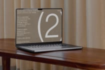 Laptop displaying design templates on screen; ideal for designers seeking premium digital assets; minimalist workspace setting; SEO keywords: templates, design.
