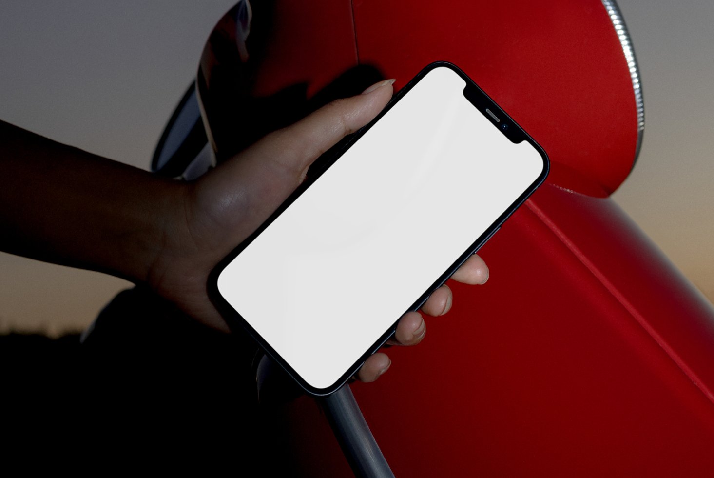Mockup of a smartphone held in a hand against a red background. Ideal for showcasing app designs and graphics. Perfect for designers.