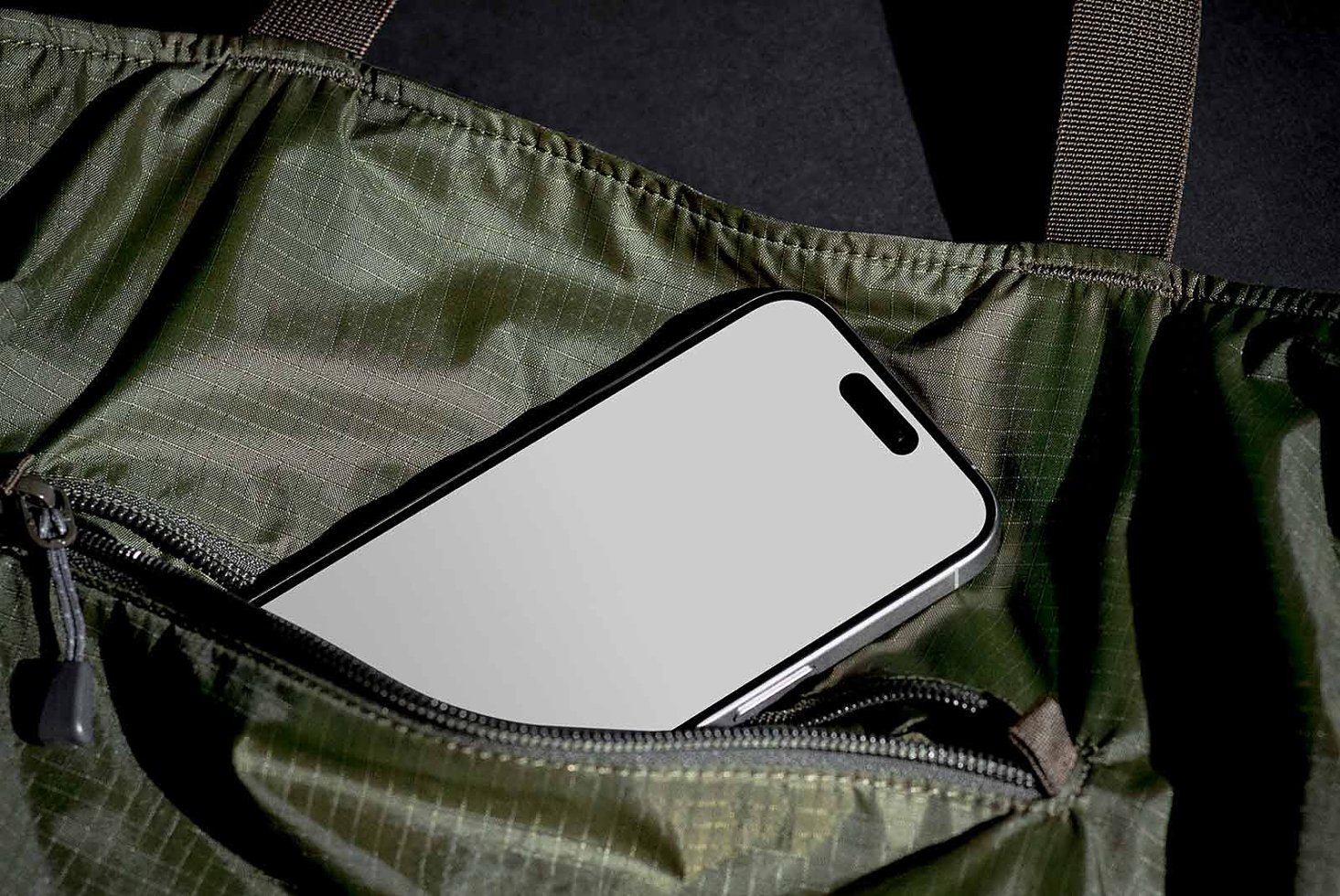 Smartphone in dark green fabric case mockup isolated on black background digital device mobile design asset for graphics and templates designers