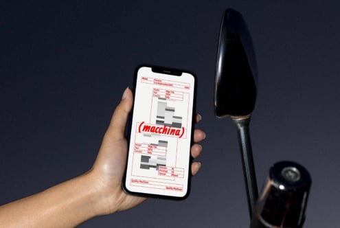 Person holds smartphone displaying a digital mockup template. Dark background and metallic rod visible. Keywords: mockups, design, template, smartphone.