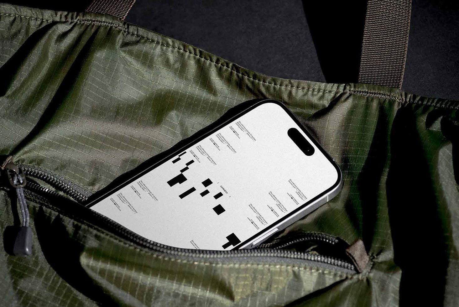Smartphone mockup displayed in a green bag pocket. Ideal for showcasing app designs or UI in digital assets for designers. High-quality visuals.