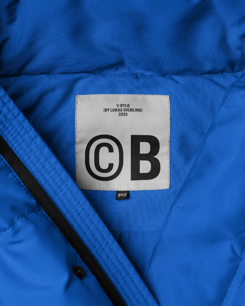 Blue fabric texture featuring a clothing label with black text suitable for apparel mockups showcasing textile design and branding for designers and creators.