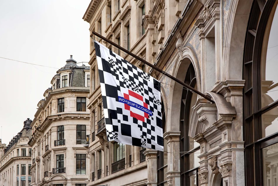 Flag hanging on ornate facade showing pixelated checkerboard with red band