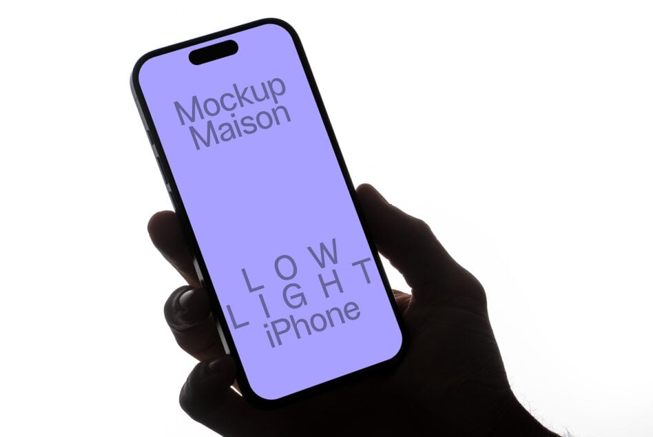 Hand gripping iPhone with purple display on neutral white background