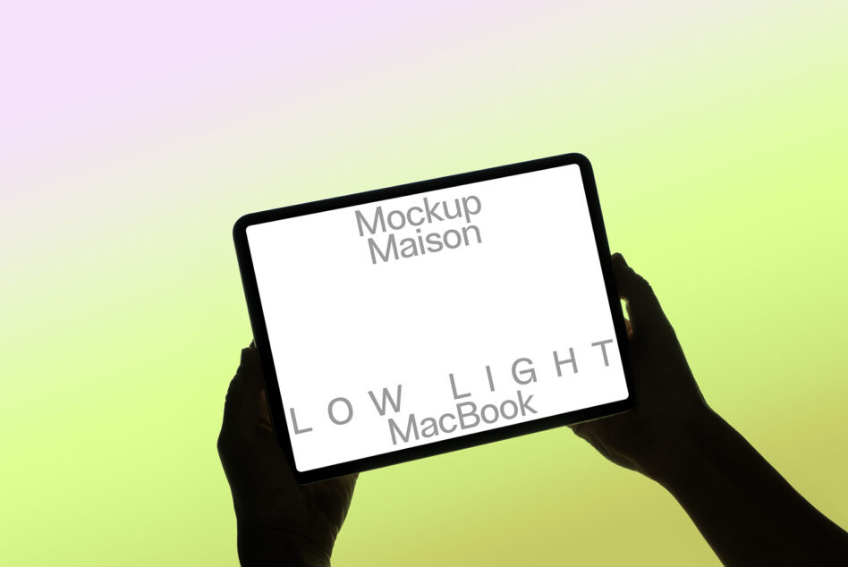 Hands holding tablet horizontally with white screen on gradient background