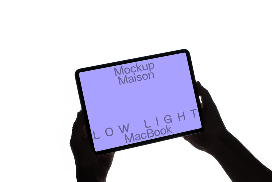 Hands holding tablet horizontally with purple display on white background