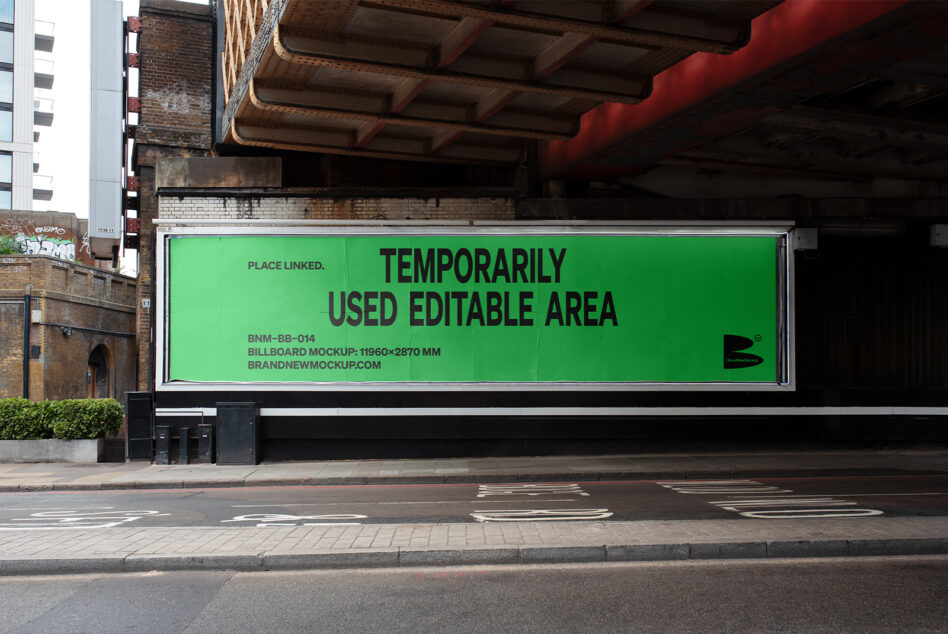 Neon green billboard mockup under industrial bridge with brick wall