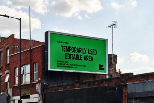 Urban billboard mockup with editable green area set against a brick building. Ideal for designers seeking realistic, customizable graphic templates.