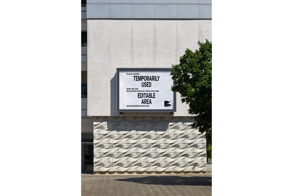 White building facade with horizontal billboard mockup mounted above textured concrete base