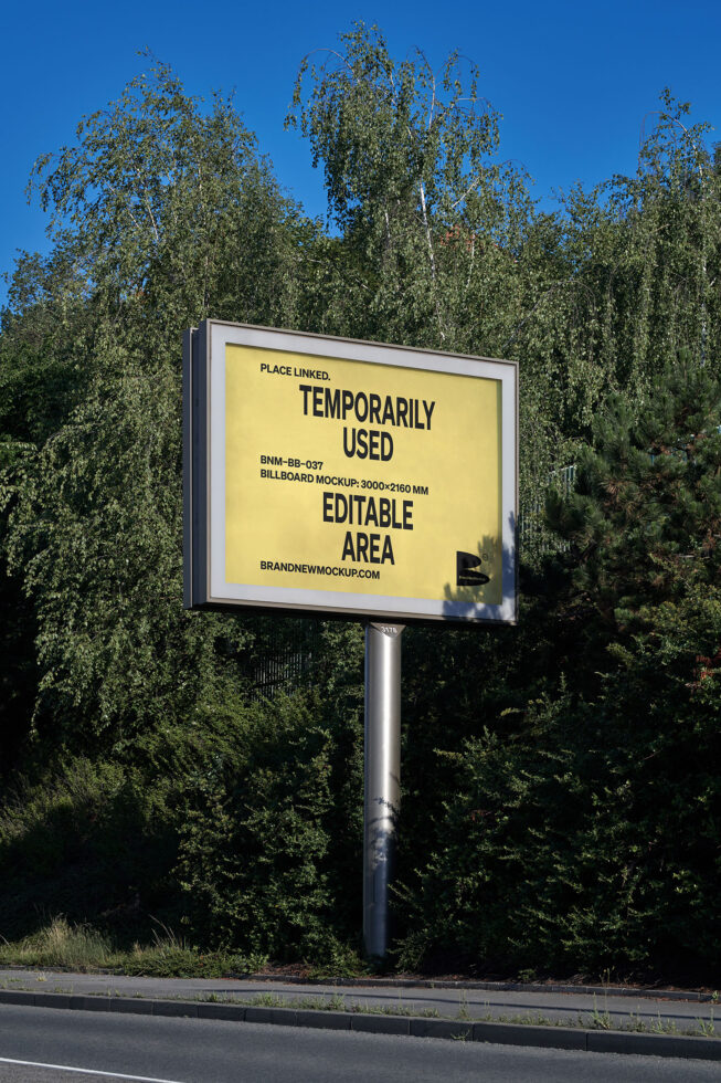 Yellow billboard mockup on pole surrounded by birch trees, bright sky