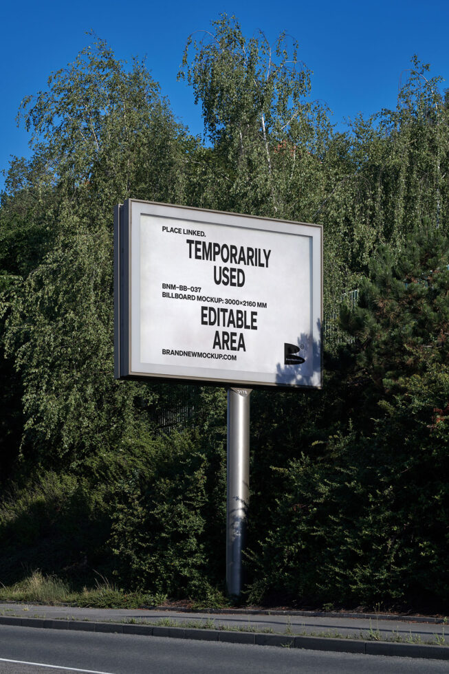 Large billboard mockup on pole with dense birch trees in background
