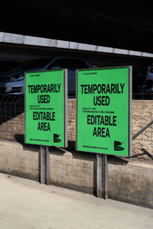 Pair of bright green poster mockups on concrete base under parking lot overhang