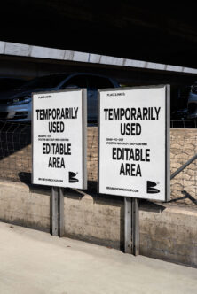 Pair of white poster mockups on concrete base under parking lot overhang