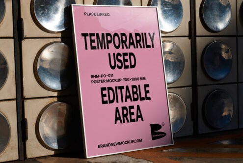 Pink poster mockup angled against metal plate wall with worn concrete floor